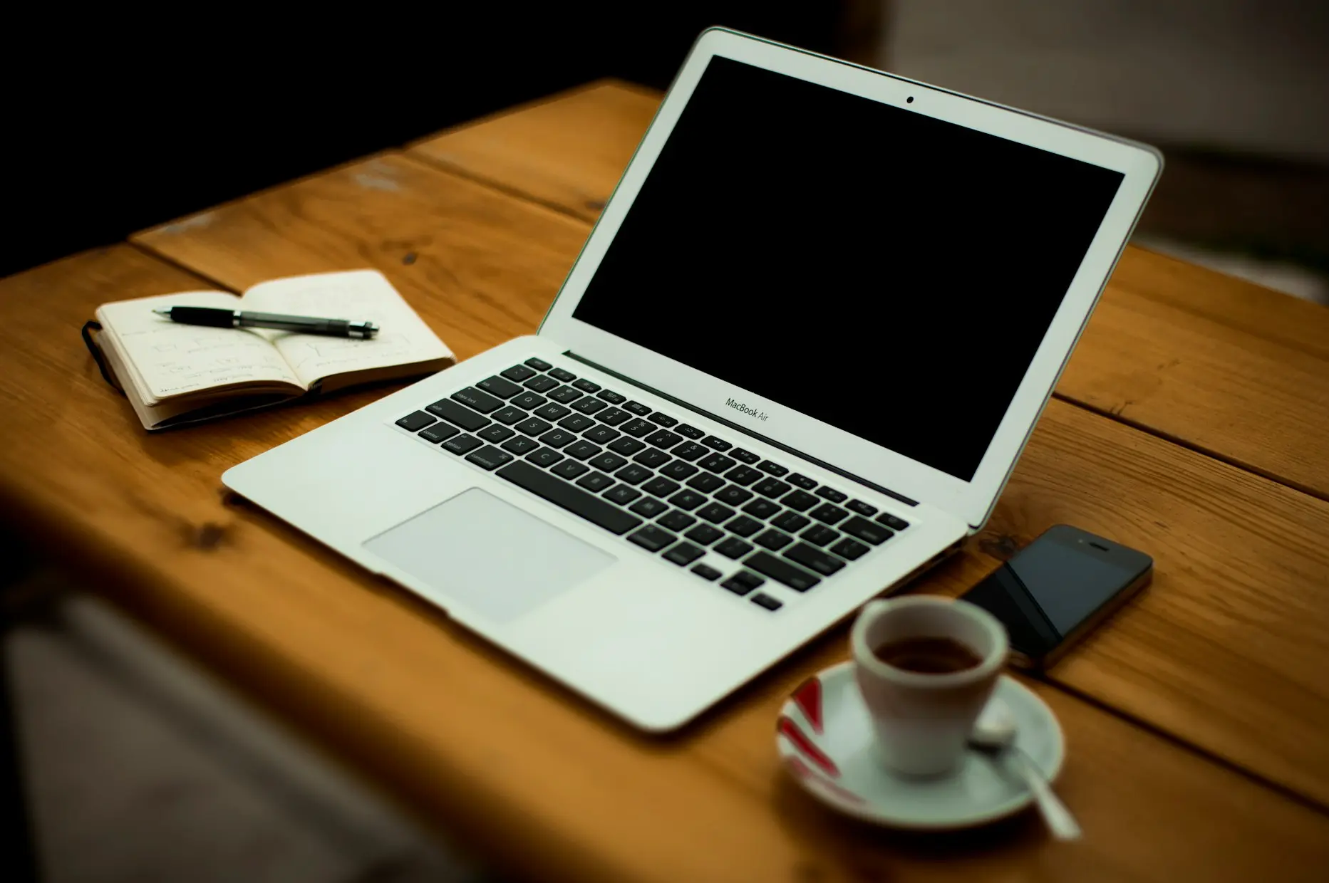 MacBook Air on brown wooden table